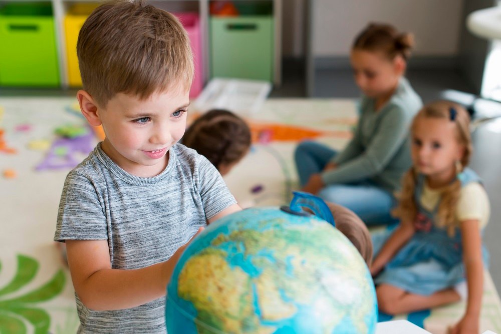 little-boy-playing-with-an-earth-globe